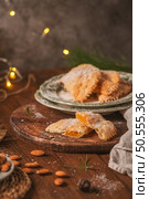 A crescent-shaped pastry whose filling is made of eggs and almonds wrapped in crispy dough, cut in an artisanal way and sprinkled with sugar. Стоковое фото, агентство Ingram Publishing / Фотобанк Лори