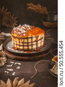 Delicious caramel cake with small pieces of pecan nuts and coconut shavings. Стоковое фото, агентство Ingram Publishing / Фотобанк Лори