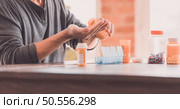 Closeup image of a man holding and opening pills box. Стоковое фото, агентство Ingram Publishing / Фотобанк Лори