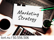 Marketing Strategy word written on white piece of paper. Стоковое фото, агентство Ingram Publishing / Фотобанк Лори