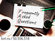 FAQ word is written on white piece of paper. Стоковое фото, агентство Ingram Publishing / Фотобанк Лори