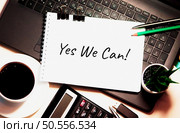 Yes we can! is written on white piece of paper. Be Brave Encouragement Time to Act Motivation Aspirations Concept. Стоковое фото, агентство Ingram Publishing / Фотобанк Лори