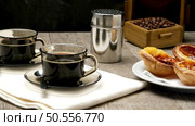 Pasteis de Nata or Portuguese Custard Tarts with black coffee on wooden table. Стоковое фото, агентство Ingram Publishing / Фотобанк Лори