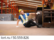 Young man working in a steel industry factory. He was critically hurt when a forklift ran over his leg and had to be transported to the hospital. Стоковое фото, агентство Ingram Publishing / Фотобанк Лори