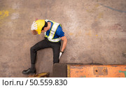 Young man working in a steel industry factory. He was critically hurt when a forklift ran over his leg and had to be transported to the hospital. Стоковое фото, агентство Ingram Publishing / Фотобанк Лори