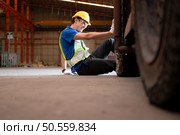 Young man working in a steel industry factory. He was critically hurt when a forklift ran over his leg and had to be transported to the hospital. Стоковое фото, агентство Ingram Publishing / Фотобанк Лори