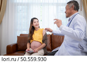 Obstetrician gynecologist and vaccination needle or pregnant woman, Asian pregnant woman visit gynecologist doctor at medical clinic for pregnancy consultant. Стоковое фото, агентство Ingram Publishing / Фотобанк Лори