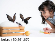 Smiling little girl and with their beloved fluffy rabbit, showcasing the beauty of friendship between humans and animals. Стоковое фото, агентство Ingram Publishing / Фотобанк Лори
