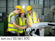 Engineer and technician discussing the robotic arm in factory about work operating, maintenance and repair. Стоковое фото, агентство Ingram Publishing / Фотобанк Лори