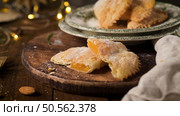 A crescent-shaped pastry whose filling is made of eggs and almonds wrapped in crispy dough, cut in an artisanal way and sprinkled with sugar. Стоковое фото, агентство Ingram Publishing / Фотобанк Лори