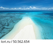 Aerial view of Nakupenda island, sandbank in ocean, empty white sandy beach, blue sea in low tide at sunny summer day in Zanzibar. Top view of sand spit, clear water, people, sky with clouds. Tropical. Стоковое фото, агентство Ingram Publishing / Фотобанк Лори