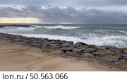 OVAR, PORTUGAL - 31 OCTOBER 2023: The sea rises to the seafront of Furadouro in Ovar. The advance of the sea due to climate change threatens Portugal. Стоковое фото, агентство Ingram Publishing / Фотобанк Лори