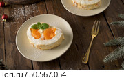 Meringue roll cake with cream and tangerine. Roulade, summer dessert served in ceramic plate. Стоковое фото, агентство Ingram Publishing / Фотобанк Лори