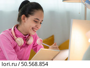 A girl ballet student in pink tracksuit, Thinking and choreographing own ballet. Стоковое фото, агентство Ingram Publishing / Фотобанк Лори