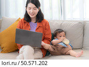 Mother and son play together after dad comes home from work. Стоковое фото, агентство Ingram Publishing / Фотобанк Лори