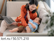 Mother and son play together after dad comes home from work. Стоковое фото, агентство Ingram Publishing / Фотобанк Лори