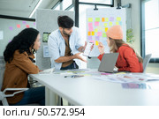 Multiethnic young business people working together in modern office, Collaborate to designing an application for use on the internet network. Стоковое фото, агентство Ingram Publishing / Фотобанк Лори
