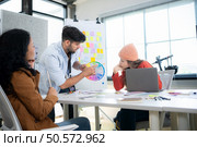 Multiethnic young business people working together in modern office, Collaborate to designing an application for use on the internet network. Стоковое фото, агентство Ingram Publishing / Фотобанк Лори