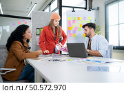 Multiethnic young business people working together in modern office, Collaborate to designing an application for use on the internet network. Стоковое фото, агентство Ingram Publishing / Фотобанк Лори