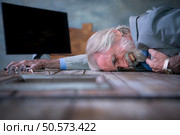 An elderly businessman suffered a sudden heart failure at work. Стоковое фото, агентство Ingram Publishing / Фотобанк Лори