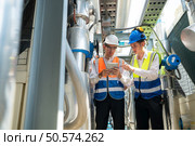 Engineers and technicians Inspect the completed air conditioning and water systems to continue verifying their functionality. Стоковое фото, агентство Ingram Publishing / Фотобанк Лори