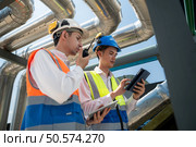 Engineers and technicians Inspect the completed air conditioning and water systems to continue verifying their functionality. Стоковое фото, агентство Ingram Publishing / Фотобанк Лори