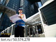 Engineers inspect the completed air conditioning and water systems to continue verifying their functionality. Стоковое фото, агентство Ingram Publishing / Фотобанк Лори