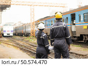 Railway technicians and engineers, Working on the train tracks at train station. Стоковое фото, агентство Ingram Publishing / Фотобанк Лори