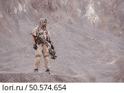 Soldiers in camouflage military uniforms carrying weapons, Reconnaissance missions in rugged mountains, Assault infantry battle training. Стоковое фото, агентство Ingram Publishing / Фотобанк Лори
