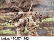 Soldiers in camouflage military uniforms carrying weapons, Reconnaissance missions in the tropical forest area, Assault infantry battle training. Стоковое фото, агентство Ingram Publishing / Фотобанк Лори