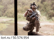 Soldiers in camouflage military uniforms carrying weapons, Reconnaissance missions in the tropical forest area, Assault infantry battle training. Стоковое фото, агентство Ingram Publishing / Фотобанк Лори