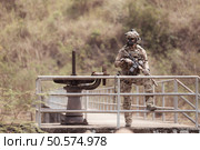 Soldiers in camouflage military uniforms carrying weapons, Reconnaissance missions in the tropical forest area, Assault infantry battle training. Стоковое фото, агентство Ingram Publishing / Фотобанк Лори