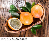 Granadilla fruits on the wooden table. Стоковое фото, агентство Ingram Publishing / Фотобанк Лори
