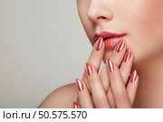 Beauty woman with perfect makeup. Glamour girl. Red lips and nails. Skin care foundation. Beauty girls face isolated on light background. Fashion photo. Стоковое фото, агентство Ingram Publishing / Фотобанк Лори