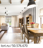 Elegant house interior with spacious dining hall and wooden vintage furnitures. Стоковое фото, агентство Ingram Publishing / Фотобанк Лори
