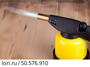 manual gas burner on a wooden background. Blowtorch. Стоковое фото, агентство Ingram Publishing / Фотобанк Лори