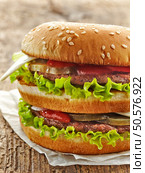 fresh big burger on a wooden table. Стоковое фото, агентство Ingram Publishing / Фотобанк Лори