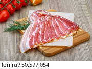 Fresh cold sliced bacon with dill branch on the wood background. Стоковое фото, агентство Ingram Publishing / Фотобанк Лори