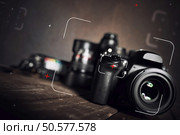 Background of professional reflex camera on wooden boards. Professional reflex camera. Стоковое фото, агентство Ingram Publishing / Фотобанк Лори