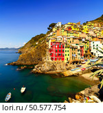 Riomaggiore village on cliff rocks and sea at sunset., Seascape in Five lands, Cinque Terre National Park, Liguria Italy Europe. Long Exposure. Стоковое фото, агентство Ingram Publishing / Фотобанк Лори