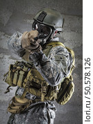 Gas Mask Soldier aiming handgun. Стоковое фото, агентство Ingram Publishing / Фотобанк Лори