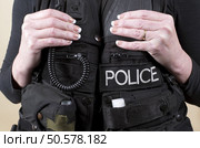 Married police officer wearing a tactical vest. Стоковое фото, агентство Ingram Publishing / Фотобанк Лори