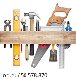 Carpentry, construction hardware tools underneath the wood plank. Стоковое фото, агентство Ingram Publishing / Фотобанк Лори