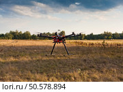Drone on a background of a beautiful sunset. UAV in flight. Quadrocopters on radio.. Oktokopter, copter, drone. Стоковое фото, агентство Ingram Publishing / Фотобанк Лори