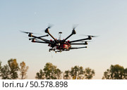 Drone on a background of a beautiful sunset. UAV in flight. Quadrocopters on radio.. Oktokopter, copter, drone. Стоковое фото, агентство Ingram Publishing / Фотобанк Лори
