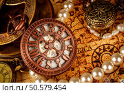 Vintage Antique pocket watch on an ancient world map in 1565.. Стоковое фото, агентство Ingram Publishing / Фотобанк Лори