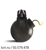 Man sitting on bomb expected to explode. Waiting to explode. Стоковое фото, агентство Ingram Publishing / Фотобанк Лори