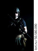 Private military contractor PMC with assault rifle on dark background. Стоковое фото, агентство Ingram Publishing / Фотобанк Лори