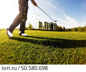 Golfer performs a golf shot from the fairway. Sunny summer day.. Golfer performs a golf shot from the fairway. Стоковое фото, агентство Ingram Publishing / Фотобанк Лори