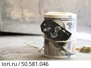 Dollar roll, tag with a dollar sign and golden coins. Стоковое фото, агентство Ingram Publishing / Фотобанк Лори